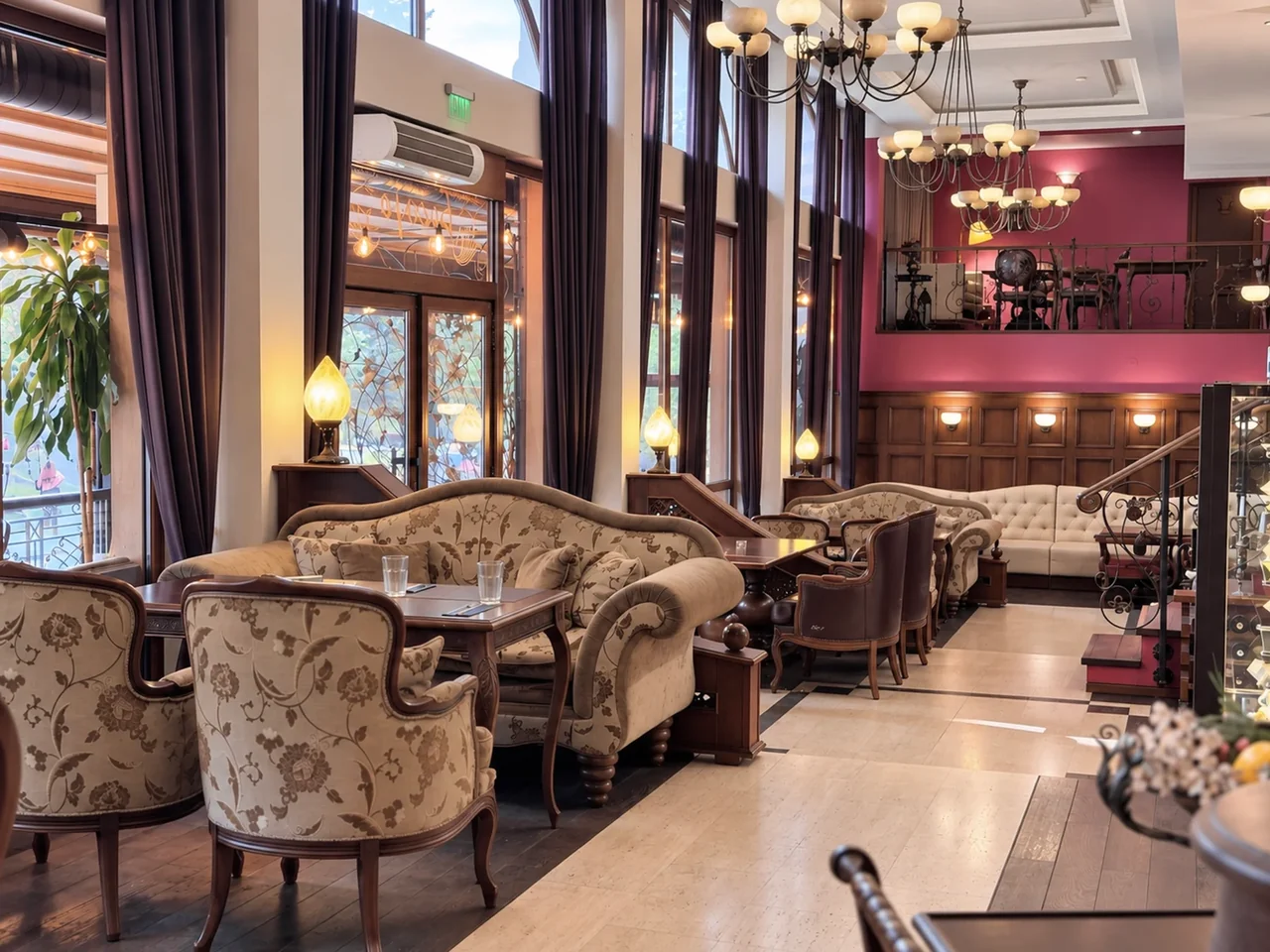 Haskovo’daki RETRO restoranının pencereleri yanında döşemeli koltuklu masalar